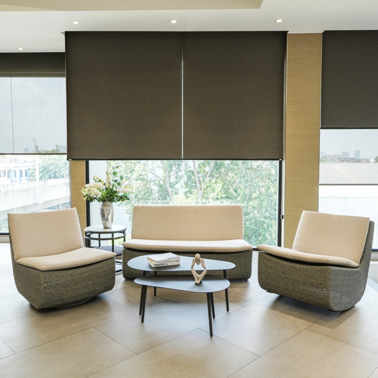 A sophisticated living room designed by Home Decor Indonesia, featuring a modern plush sofa, elegant armchairs, and a harmonious color palette that creates a luxurious and comfortable atmosphere.