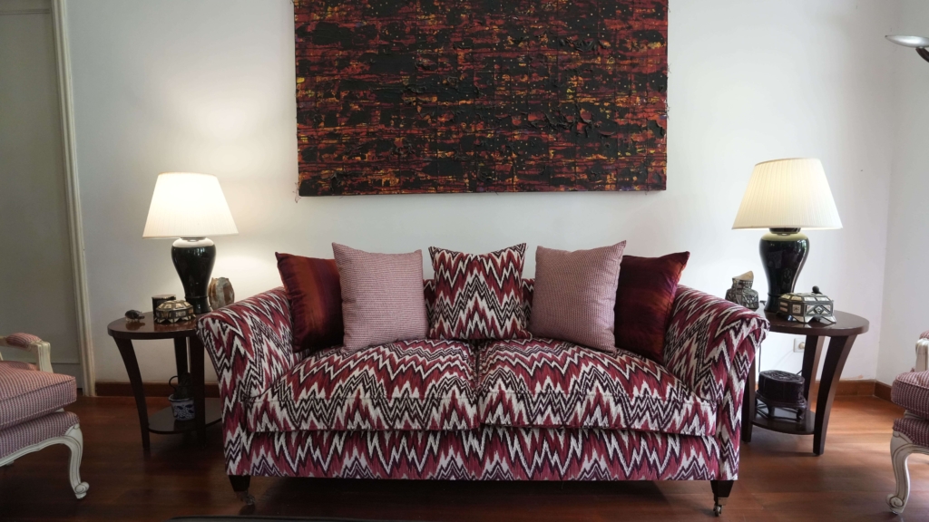 A beautifully styled living room interior by Home Decor Indonesia, featuring a coordinated furniture set with elegant textiles and ambient lighting that creates a warm, inviting, and luxurious atmosphere.