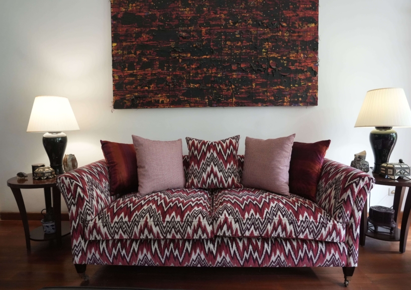 A beautifully styled living room interior by Home Decor Indonesia, featuring a coordinated furniture set with elegant textiles and ambient lighting that creates a warm, inviting, and luxurious atmosphere.