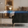 A side-profile shot of a luxury armchair next to a side table.