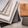 A flat-lay photo showing different fabric swatches next to a piece of solid wood and a metal accent