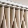 A close-up shot of the top of a Gorden Minimalis. Focus on the S-Fold hardware and the perfect, uniform wave of the fabric