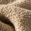 An extreme close-up macro photograph of the bouclé fabric.